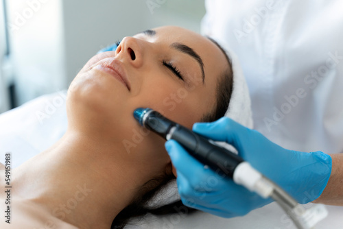 Фотография Close-up of woman getting facial hydro microdermabrasion peeling treatment
