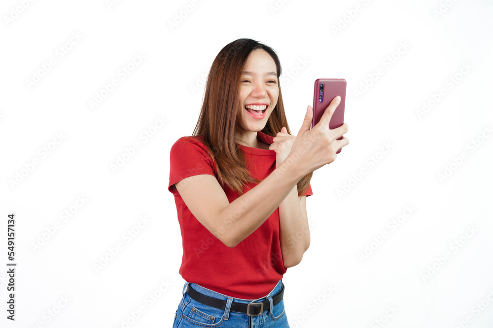 Holding mobile, Pretty asian women England soccer fans celebrating over white background isolated. Sports fan isolated young woman. Holding mobile, Pretty asian women England soccer fans celebrating over white background isolated. Sports fan isolated young woman.