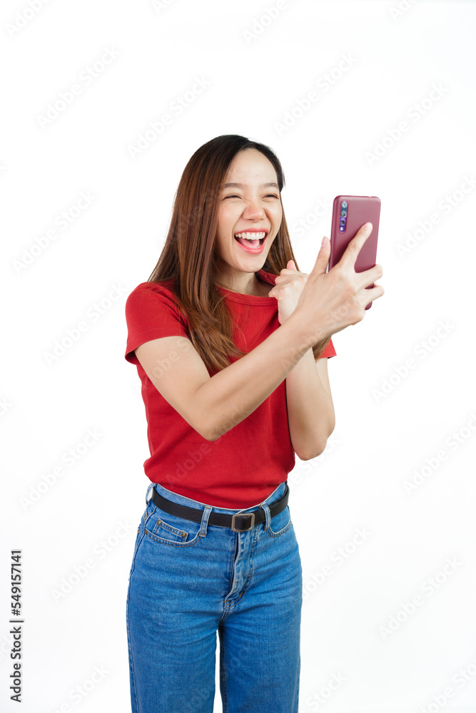 Holding mobile, Pretty asian women England soccer fans celebrating over white background isolated. Sports fan isolated young woman. Holding mobile, Pretty asian women England soccer fans celebrating over white background isolated. Sports fan isolated young woman.