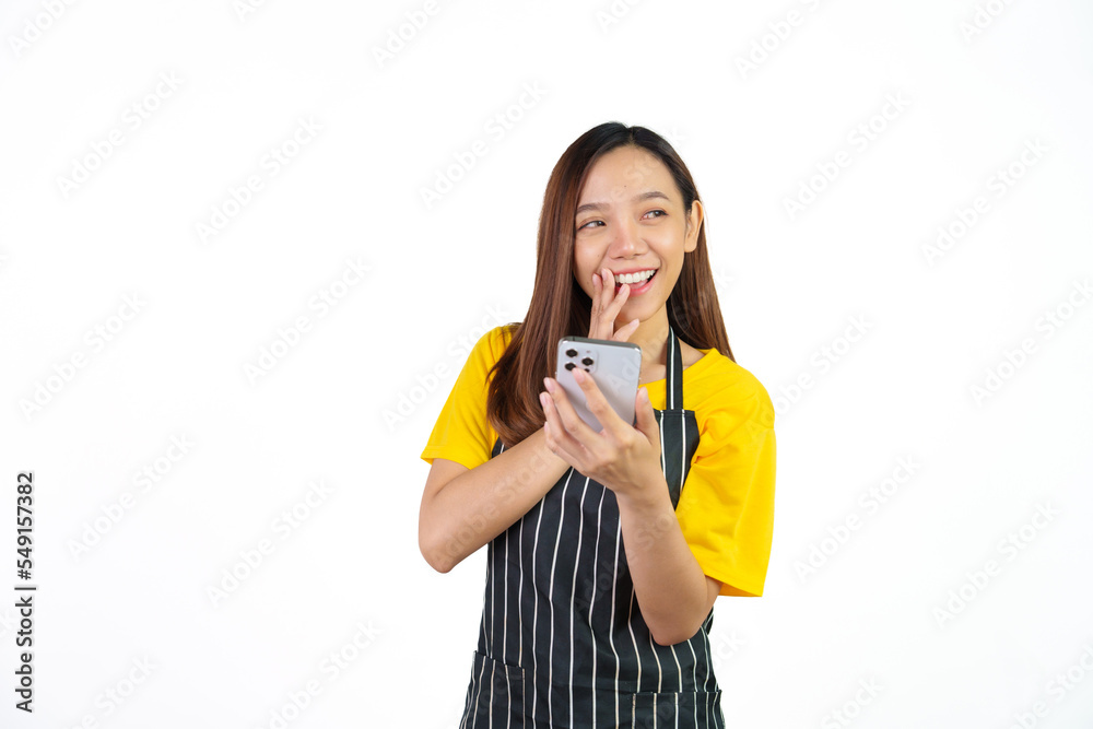 Received customer online order on mobile app, Portrait of confident asian woman barista and food owner shop with yellow t-shirt and black apron standing on white background. Received customer online order on mobile app, Portrait of confident asian woman barista and food owner shop with yellow t-shirt and black apron standing on white background.
