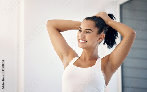 Woman, hair care and ponytail at home with a smile, beauty and happiness while getting ready with self care for morning routine. Female with a smile for motivation, self love and wellness in house