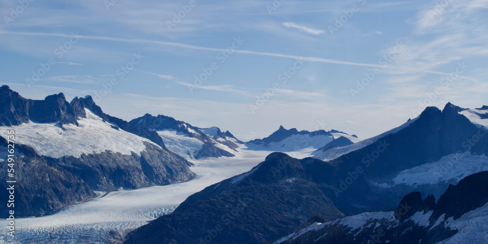Alaska mountain range snow and ice and glacier and blue sky and white clouds