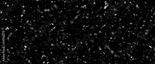 Snowfall bokeh on dark foundation. Numerous snowflakes in flying in the air. Winte night snowfall and snowstorm of snow at. Obscure bokeh light impact innovative foundation.