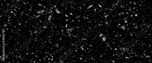 Different realistic falling snow or snowflakes. Falling snow isolated on black background. Winter snowfall illustration. Bokeh lights on black background, flying snowflakes in the air. Snow at night.