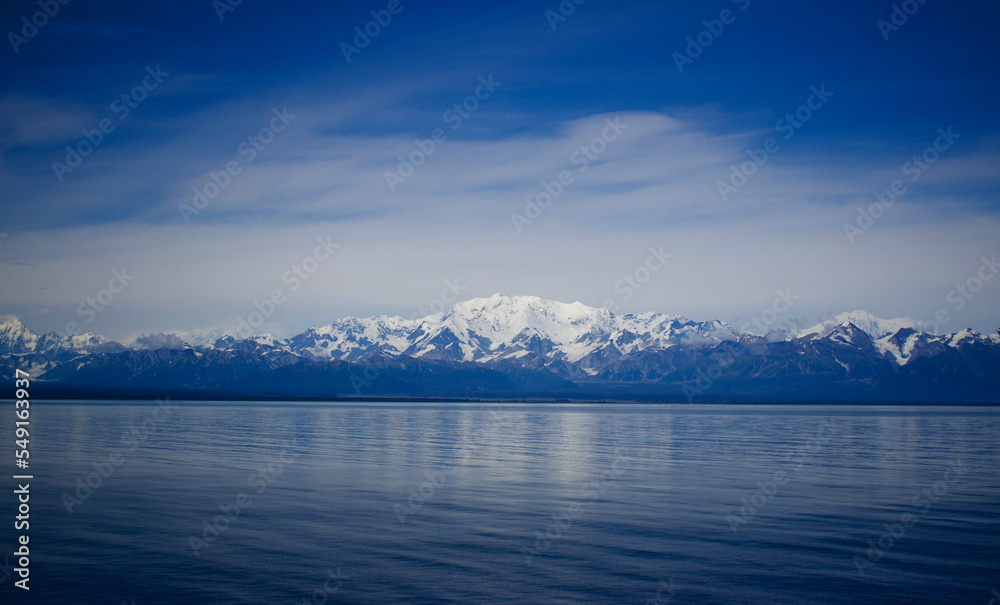 Alaska mountain range and coastline and calm waters