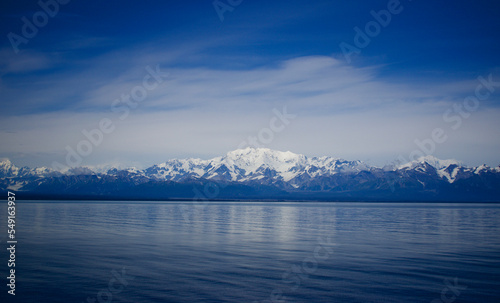 Alaska mountain range and coastline and calm waters