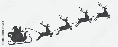 Foto illustration of santa clause riding his sleigh pulled by reindeers