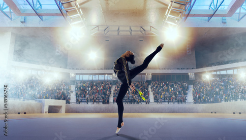 Rhythmic gymnast in professional arena. © VIAR PRO studio