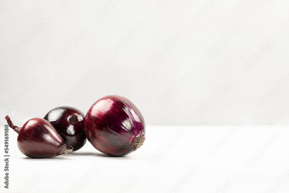 Red onion on a light background close-up Red onion on a light background close-up