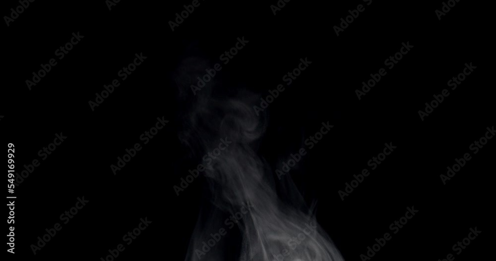 White steam isolated on black. Trickle of Steam Slowly Rising from the Cup. White steam rises graceful twists on a black background. Footage is perfect for the layer with different blending modes. White steam isolated on black. Trickle of Steam Slowly Rising from the Cup. White steam rises graceful twists on a black background. Footage is perfect for the layer with different blending modes.