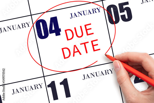 Hand writing text DUE DATE on calendar date January 4 and circling it. Payment due date