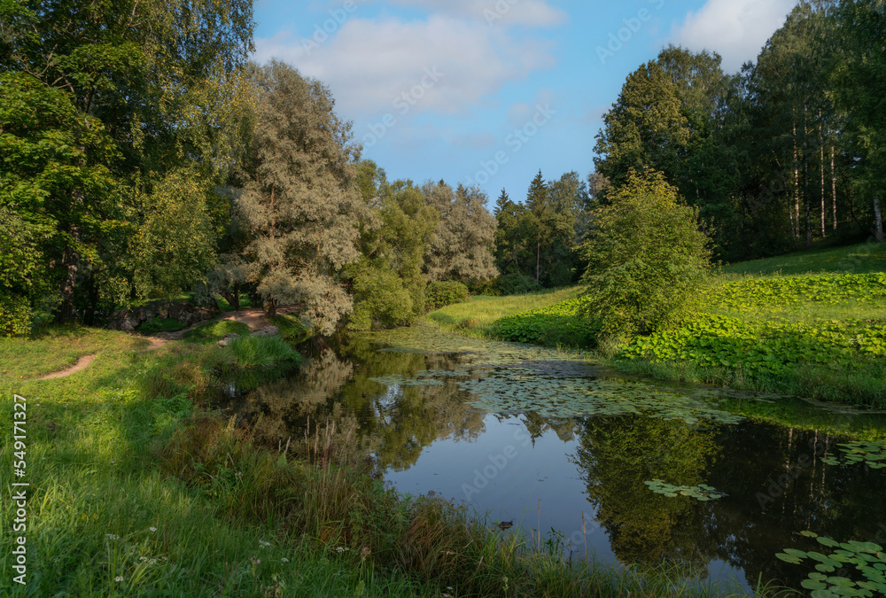 Slavyanka River in the Pavlovsk Palace and Park Complex on a sunny summer day, Pavlovsk, Saint Petersburg, Russia