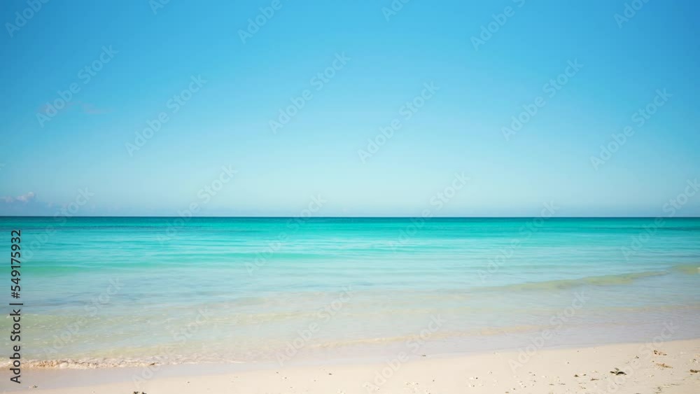 Beautiful background of beach and sea under blue sky. Landscape of the sea surface. Big calm waves of the Caribbean Sea on the white sands of the Dominican beach. Ocean and sky landscape. Beautiful background of beach and sea under blue sky. Landscape of the sea surface. Big calm waves of the Caribbean Sea on the white sands of the Dominican beach. Ocean and sky landscape.