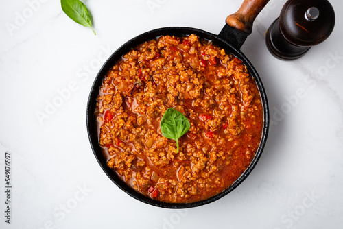 Meat tomato sauce in pan bolognese on marble surface food photo