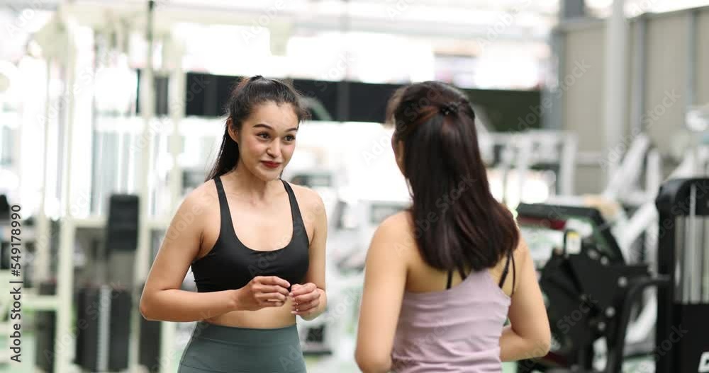 Asian woman exercise with personal trainer in gym. Young healthy woman workout in fitness with personal coach. Exercises and fitness GYM concept. Asian woman exercise with personal trainer in gym. Young healthy woman workout in fitness with personal coach. Exercises and fitness GYM concept.