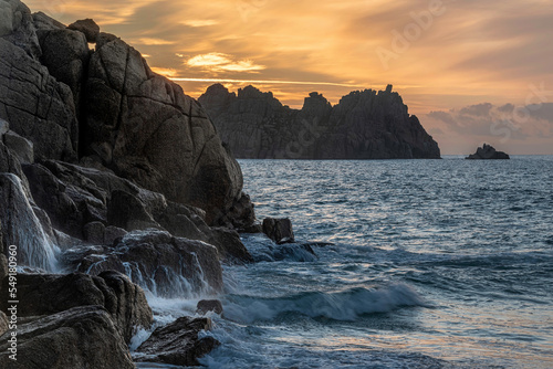 Majestic sunrise landscape at Porthcurno beach in Cornwall England with stunning colours and atmosphere photo