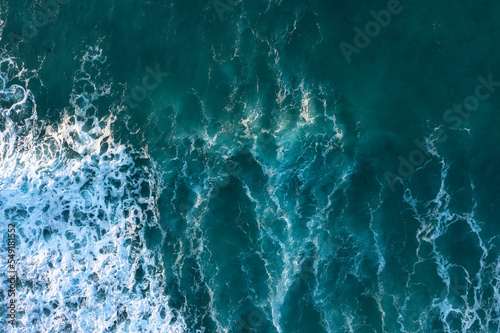 Beautiful aerial drone landscape top down view of wave detail in turquoise colored receding waves