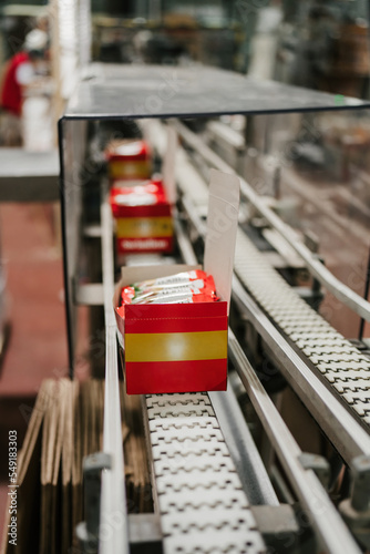 Huge factory line for sweet food and cookies production. Close up shots of industrial manufacturing packaging process.