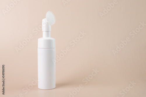 Face cleanser, Facial skin care, skincare bottle, Cosmetics foam pump container on a beige natural background