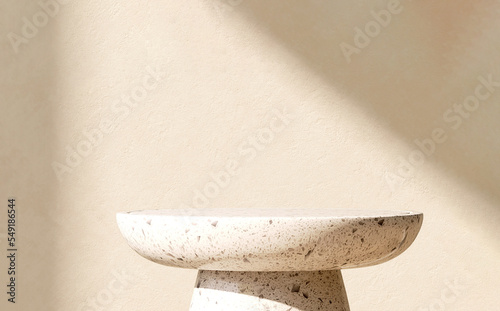 Modern and minimal round white terrazzo granite pedestal table podium with sunlight and shadow on beige brown wall for luxury, beauty, cosmetic product display background