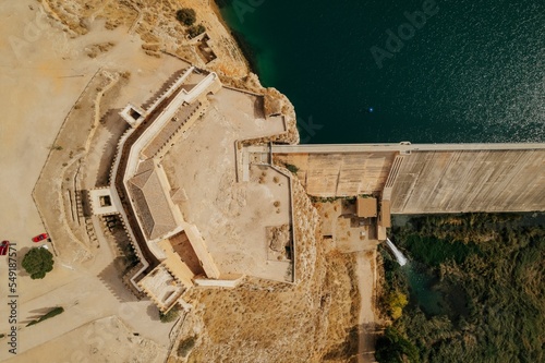 Aerial of Pennarroya castle in Argamasilla de Alba, Spain at the coast of lake El Embarcadero