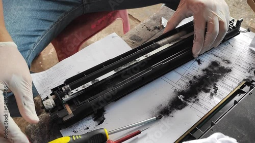 The expert technician is repairing a copier drum so it can be used again.