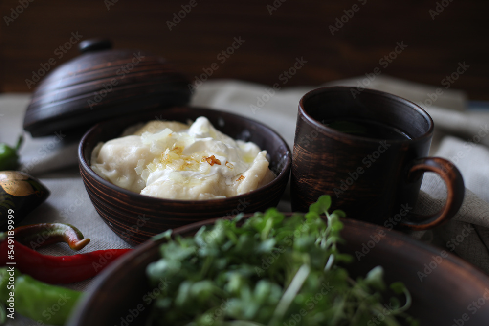 boiled hot dumplings in a clay pot with fried onions and sour cream and hot peppers
boiled hot dumplings in a clay pot with fried onions and sour cream and hot peppers