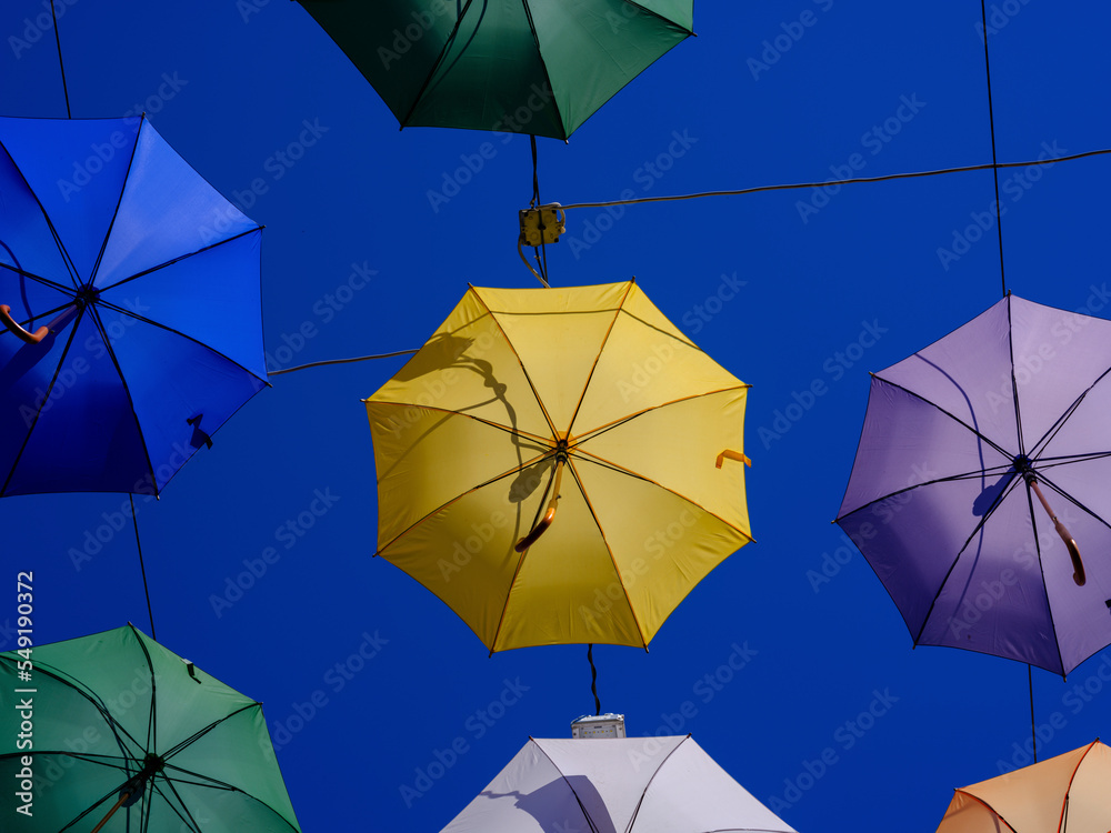 Colorful and beautiful umbrellas hanging in the city street decoration