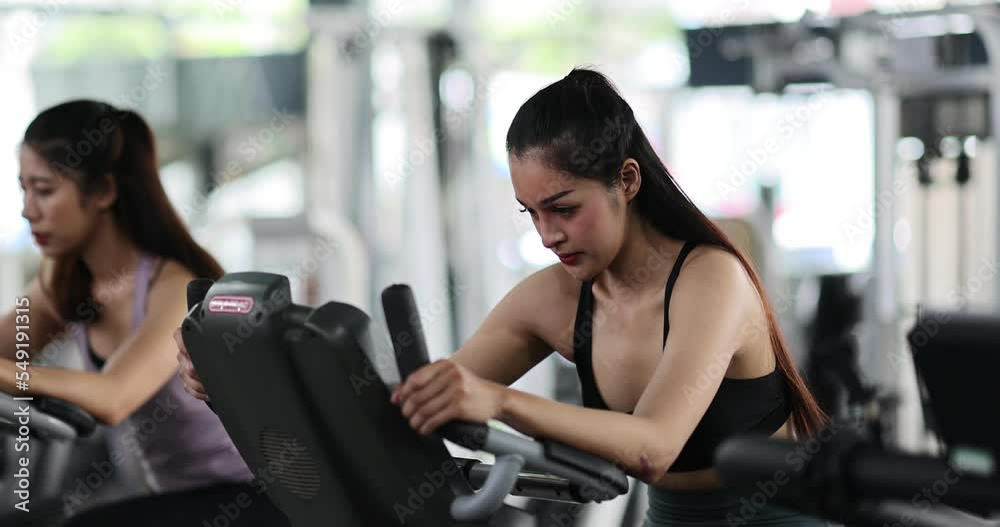 Asian woman exercise with personal trainer in gym. Young healthy woman workout in fitness with personal coach. Exercises and fitness GYM concept. Asian woman exercise with personal trainer in gym. Young healthy woman workout in fitness with personal coach. Exercises and fitness GYM concept.