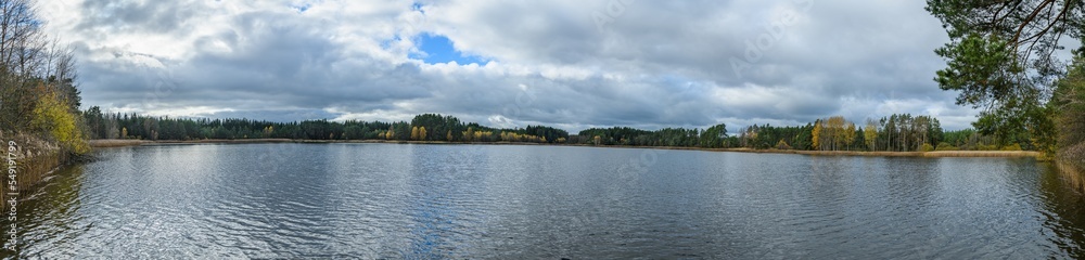 panorama landscape with pond and clouds in autumn