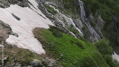 A breathtaking close-up aerial view of the water rushing over the edge of the picturesque Sofiysky waterfall. Karachay-Circassian Republic. North Caucasus photo