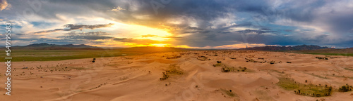 Sand dunes in desert at sunset