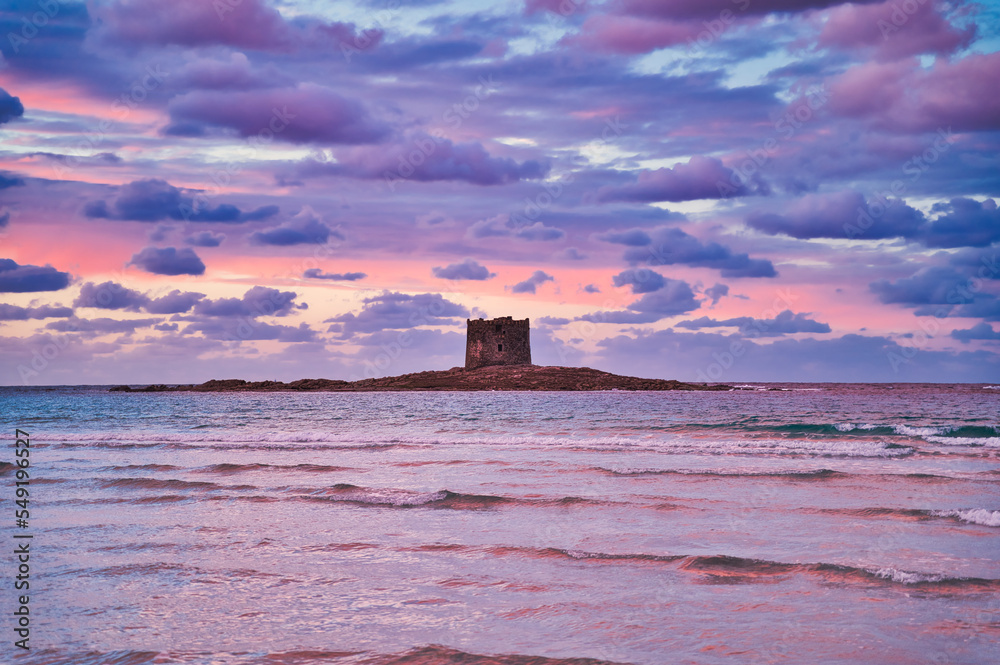 Fantastic sunset at Stintino with cloudy sky at La Pelosa Beach and the tower  island 