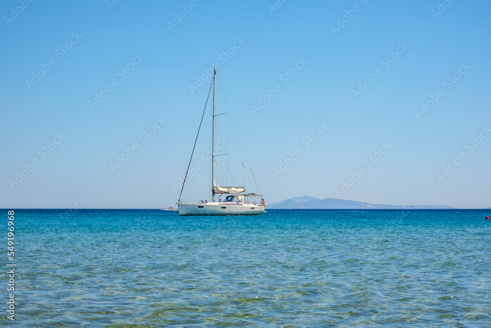 A sailboat at the famous Mylopotas beach in Ios Greece A sailboat at the famous Mylopotas beach in Ios Greece
