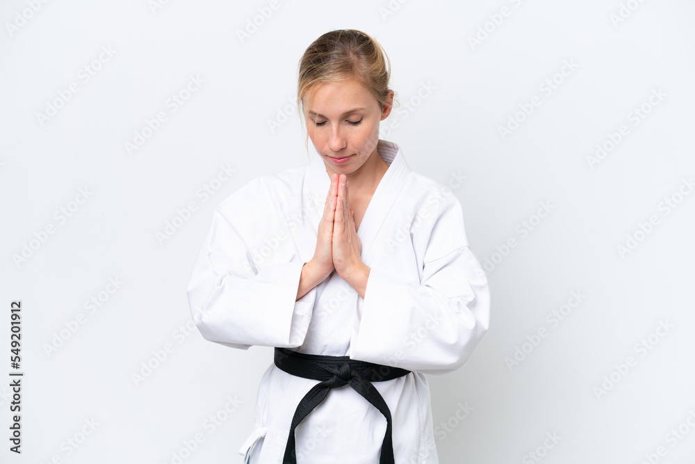 Young caucasian woman isolated on white background doing karate and saluting Young caucasian woman isolated on white background doing karate and saluting