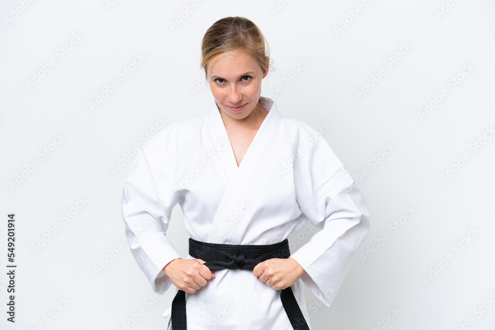 Young caucasian woman isolated on white background doing karate