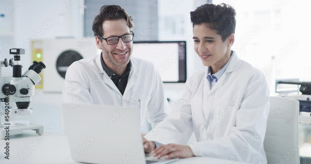 Scientist, high five and laptop in laboratory, research analysis and online results. Collaboration, man and woman hand gesture, for breakthrough and medical innovation results for health and success. Scientist, high five and laptop in laboratory, research analysis and online results. Collaboration, man and woman hand gesture, for breakthrough and medical innovation results for health and success.
