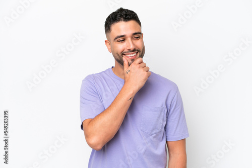 Young Arab handsome man isolated on white background looking to the side and smiling