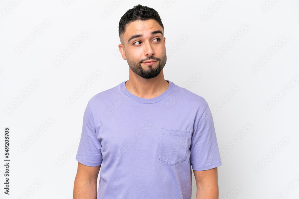 Young Arab handsome man isolated on white background making doubts gesture looking side Young Arab handsome man isolated on white background making doubts gesture looking side
