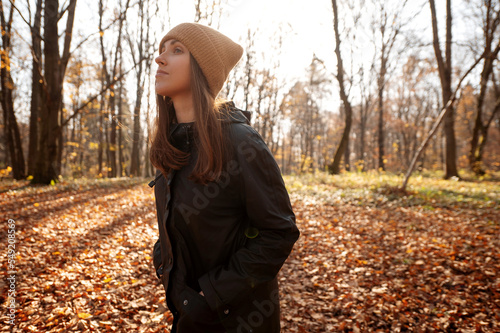 Calm positive woman enjoy autumn weather looking away and thinking about her life