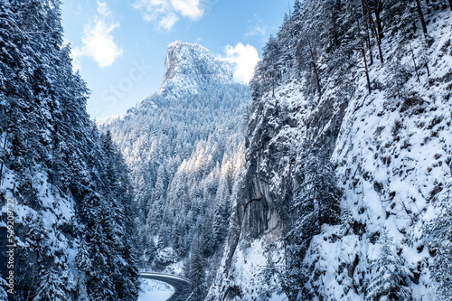 Carpathian, Romania, 2021-12-28. Road crossing two snow-covered mountainsides.