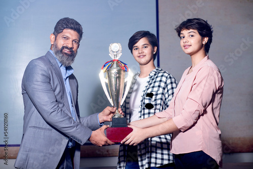 Billede på lærred Indian man school teacher give victory trophy cup to girl students, Female receive winning prize