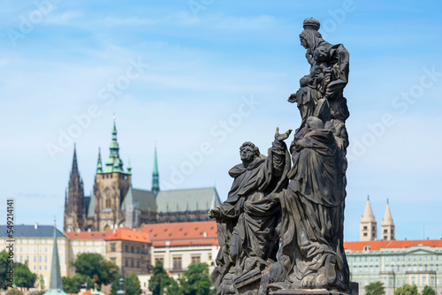Statue Of The Madonna, St. Dominic And Thomas Aquinas With Saint Vitus Cathedral On The Background, Prague, Czech Republic