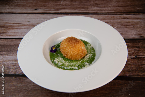 Recipe Breaded soft-boiled eggs and creamed spinach with parmesan. High quality photo