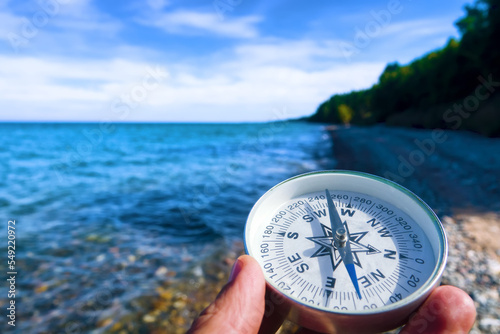 The right compass is always needed for travelers, adequate course. Hiking on the shore of Lake Baikal in Siberia photo