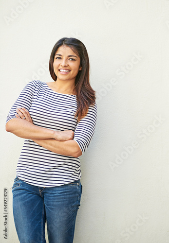 Fashion, portrait and woman with arms crossed on wall with mock up space. Happy, smile and fashionable, cool and confident comic female from Brazil smiling, cheerful and excited for life with mockup.