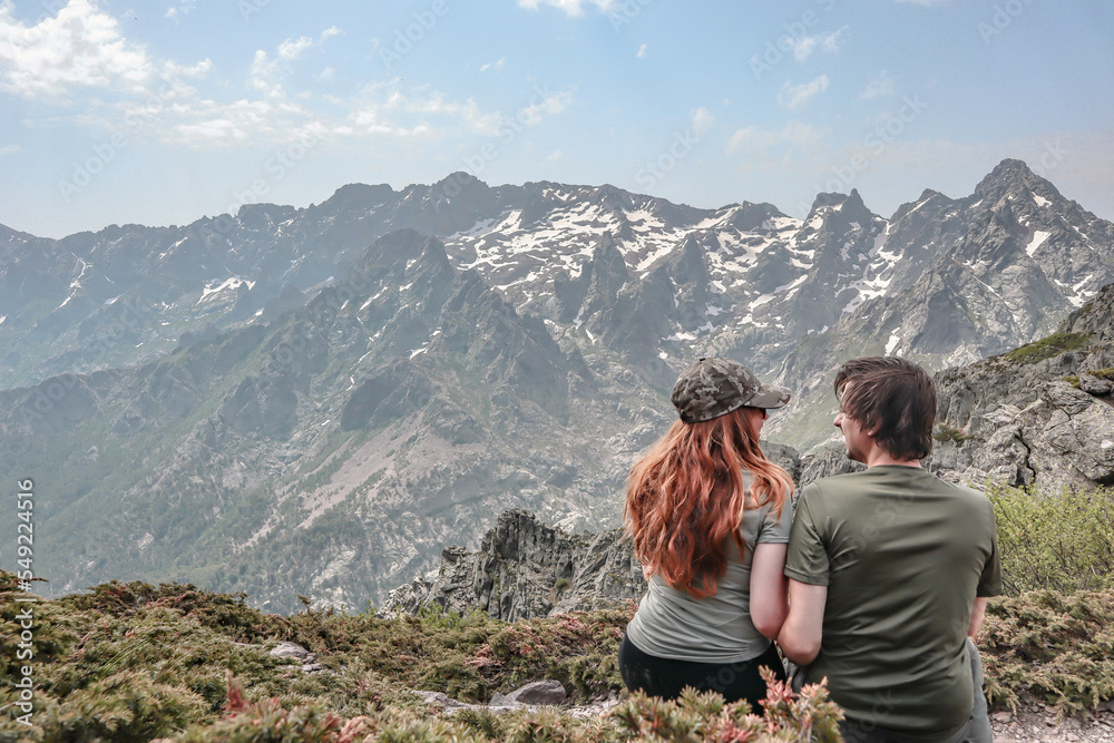 Fototapeta premium Couple enjoying the mountain views during the GR20 hike in Corsica.