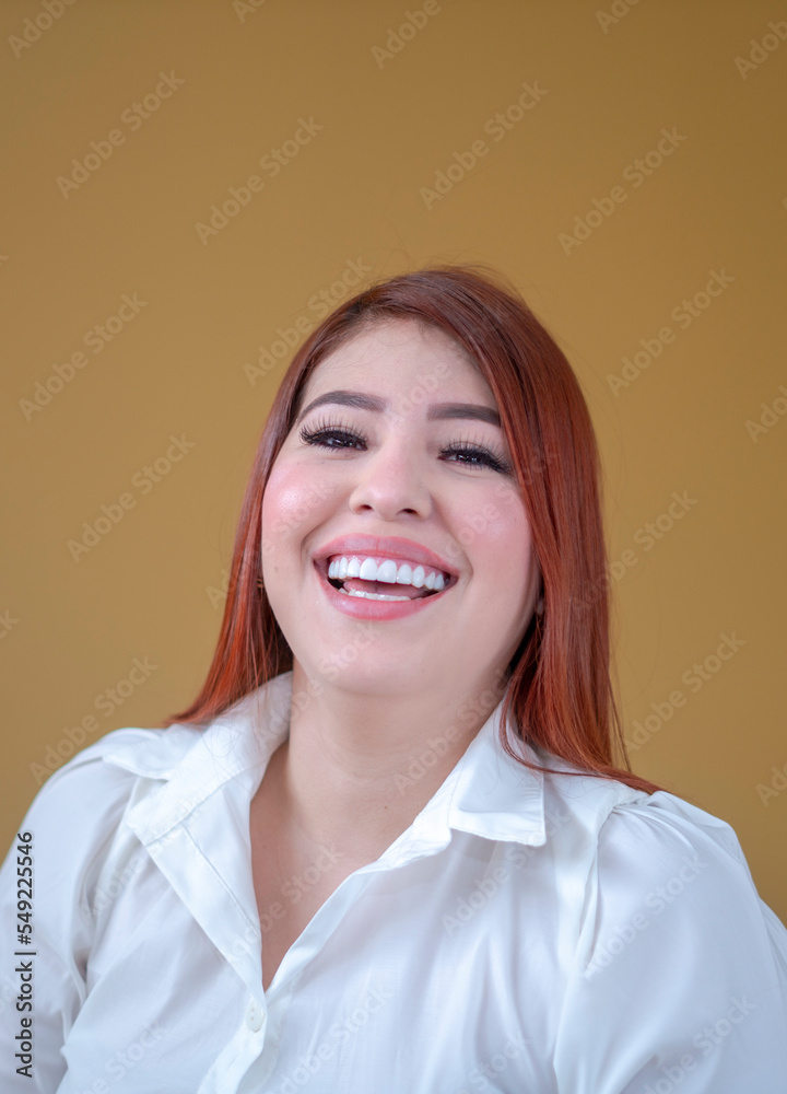 happy woman, enjoying a mustard yellow background, a beautiful smile and a white shirt happy woman, enjoying a mustard yellow background, a beautiful smile and a white shirt
