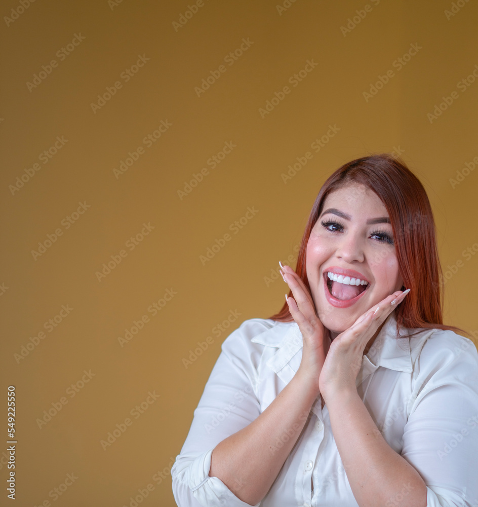 happy woman, enjoying a mustard yellow background, a beautiful smile and a white shirt happy woman, enjoying a mustard yellow background, a beautiful smile and a white shirt