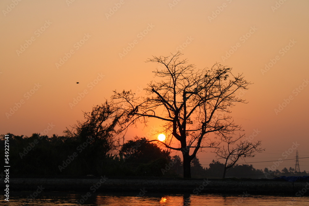 Naklejka premium sun set sun rise boat ocean lake reflection